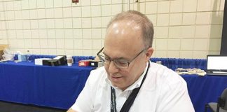 Lang examines coins at the NGC booth