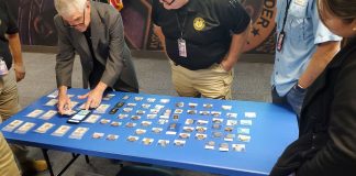 Doug Davis setting up counterfeits display