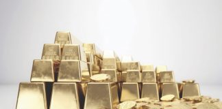 Gold bar and gold coin on white background.